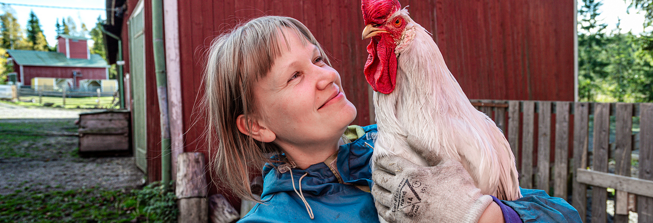 Woman holding a chicken